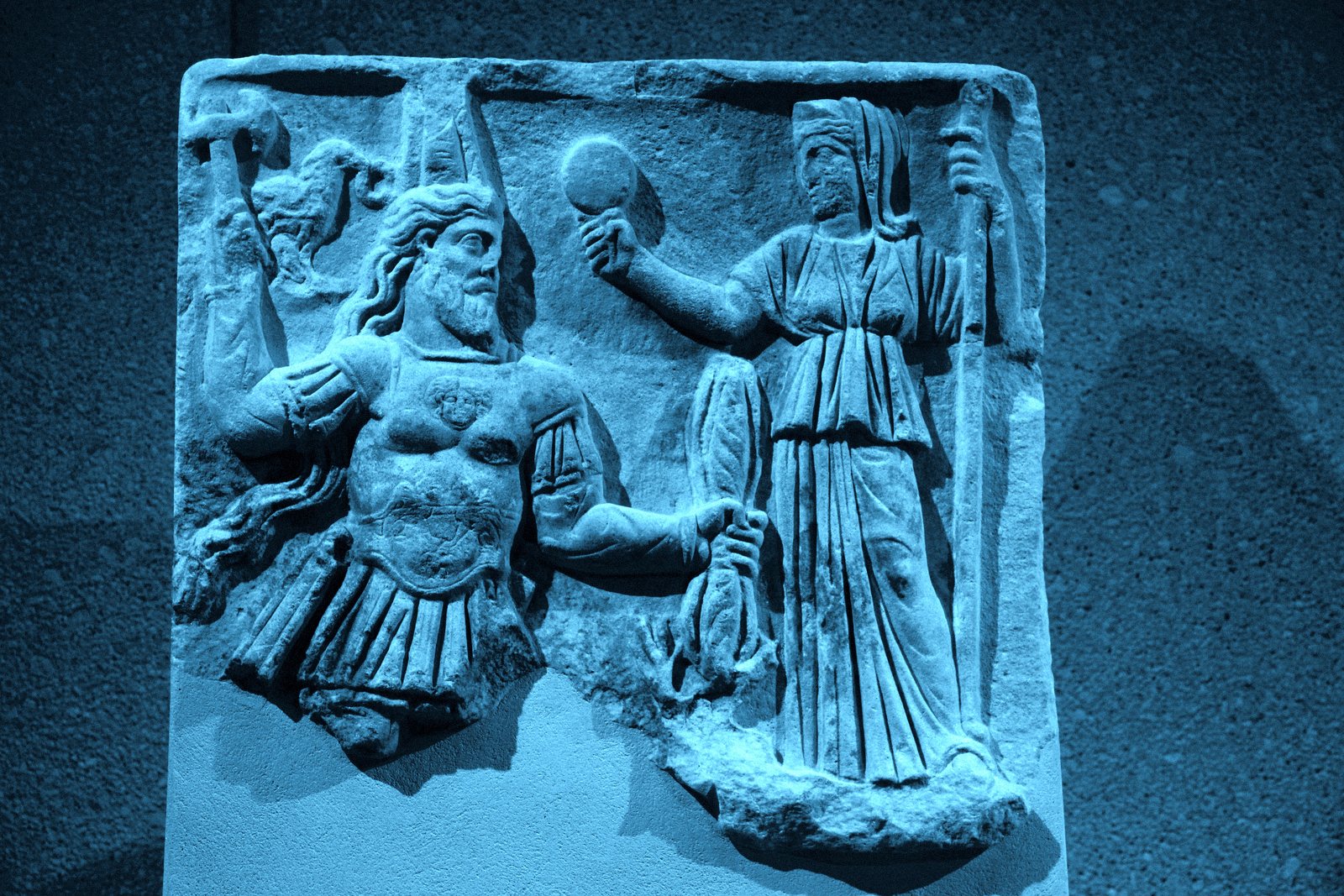 Roman marble votive relief of Jupiter and Juno; the god holds his thunderbolt.